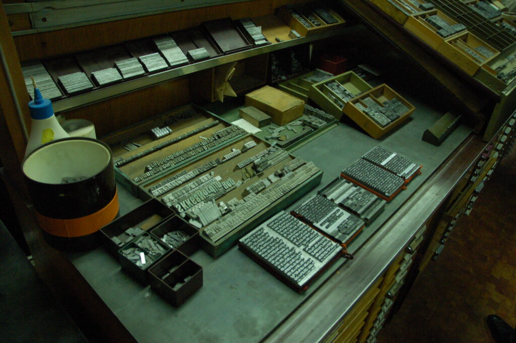 Photograph of printer's desk with type-setting tools